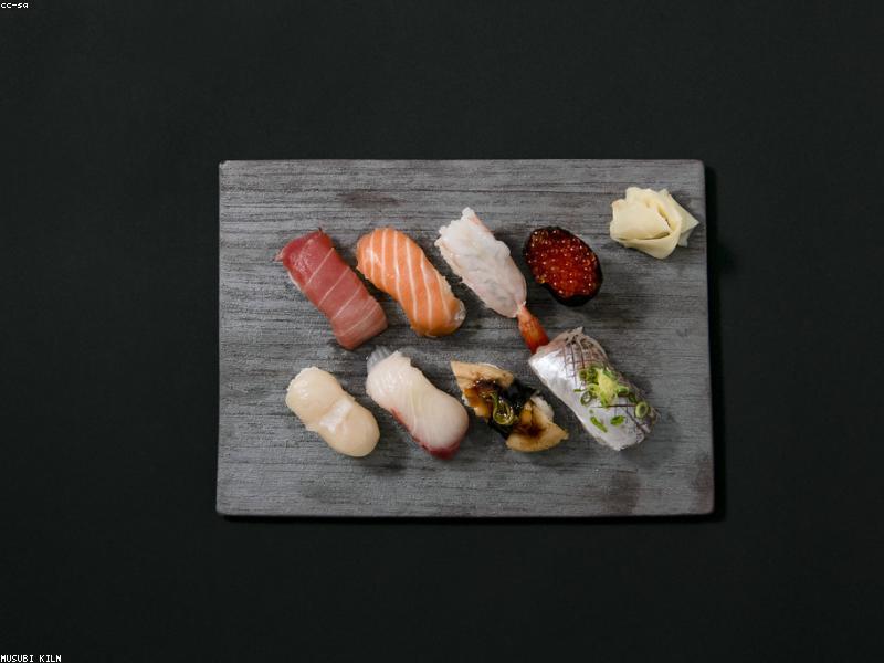 Sushi platter arranged on dark slate
